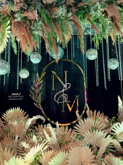 A detailed shot of the monogram and hanging disco balls, a perfect blend of rustic and glamorous styles.