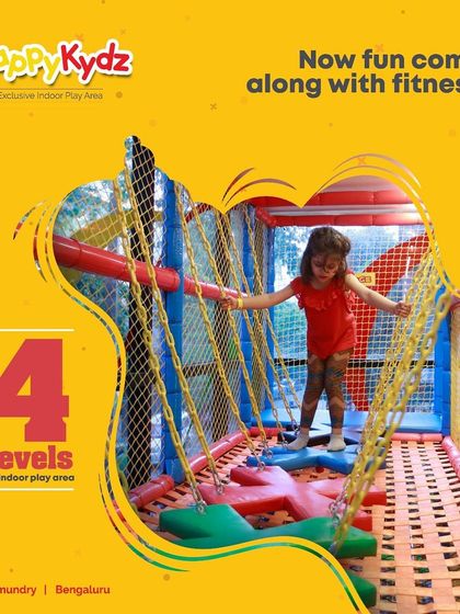 A child confidently crosses a rope bridge in our multi-level play area. These activities are not just fun; they help build fitness, balance, and problem-solving skills.