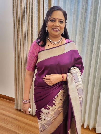 The client looks happy and ready for her party. The open pallu drape is a classic choice that never goes out of style.