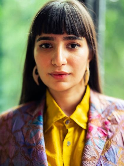 A portrait from the brocade suit look. The colors are vibrant and the overall feel is confident and contemporary.