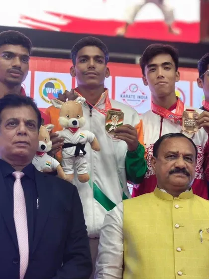With a group of young medal winners and a government dignitary. We provide a platform where talent is recognized and celebrated at the highest level.
