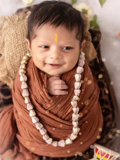 A sweet, smiling baby Vrishank, named for Lord Shiva. His happy expression is a true blessing to capture.