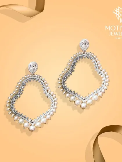 A pair of oversized hoop earrings, exquisitely crafted with diamonds and pearls. This design is a bold statement, blending classic materials with a modern silhouette.