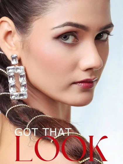 A close-up beauty shot with a focus on the eyes and accessories. The text overlay 'Got That Look' emphasizes the model's captivating presence.