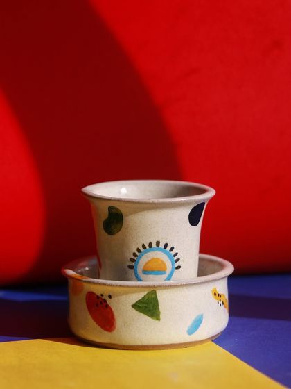 A small cup and bowl set from the 'Playful Mornings' collection, perfect for a child's breakfast or a cheerful espresso.