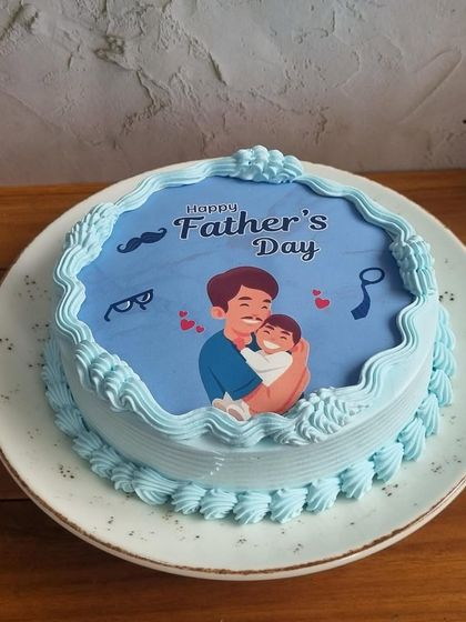 Show Dad he's your hero with a personalized Father's Day cake. This design features a sweet illustration of a father and child, making it a heartfelt gift.
