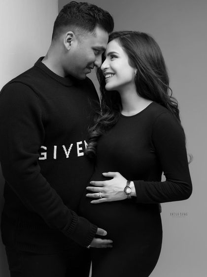 A moment of shared laughter and love between an expecting couple, made even more timeless and emotional in black and white.