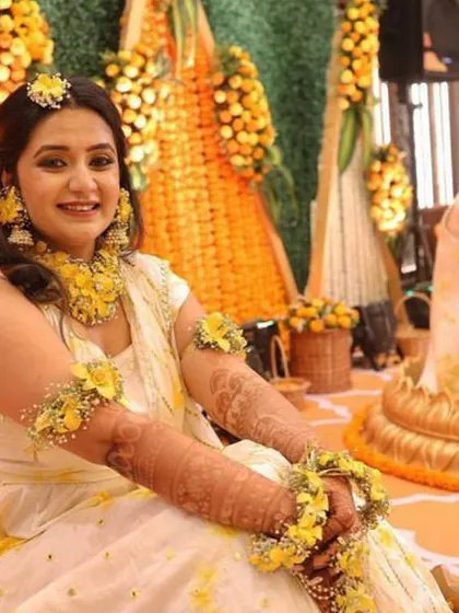A candid moment from a Haldi ceremony I designed. The backdrop of marigold and tuberose strings provides a classic, fragrant setting that perfectly complements the joyous occasion.