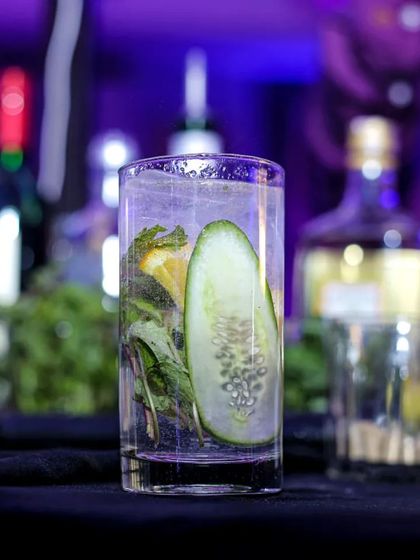 A refreshing cucumber-based cocktail, perfect for a hot day. The clear glass showcases the fresh ingredients, highlighting my commitment to using quality produce.
