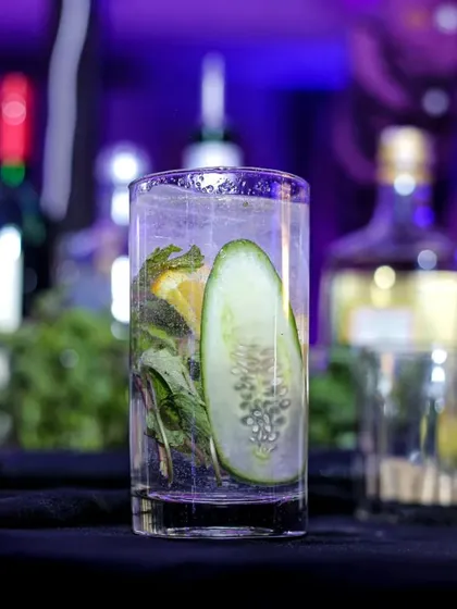 A refreshing cucumber-based cocktail, perfect for a hot day. The clear glass showcases the fresh ingredients, highlighting my commitment to using quality produce.