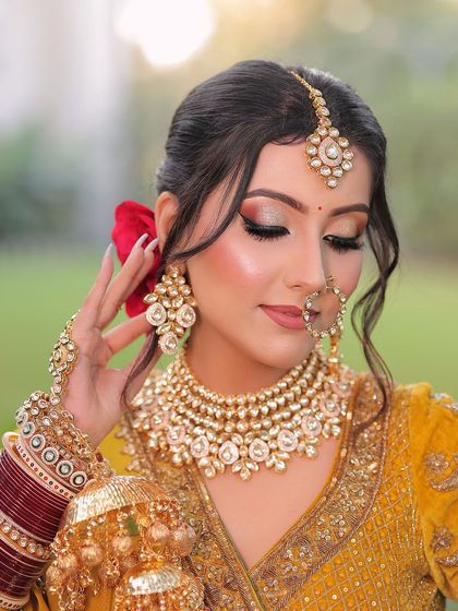 Just as the moon brightens the night, her beauty shines. This close-up shows the detailed eye makeup with a touch of glitter, paired with a soft nude lip for a magical bridal look.