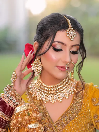 Just as the moon brightens the night, her beauty shines. This close-up shows the detailed eye makeup with a touch of glitter, paired with a soft nude lip for a magical bridal look.
