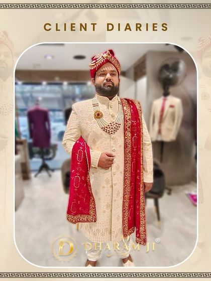 This groom is ready for his big day in a custom-made ivory sherwani with delicate embroidery, a matching necklace, and a vibrant red pagri and stole. It's a complete, majestic look.