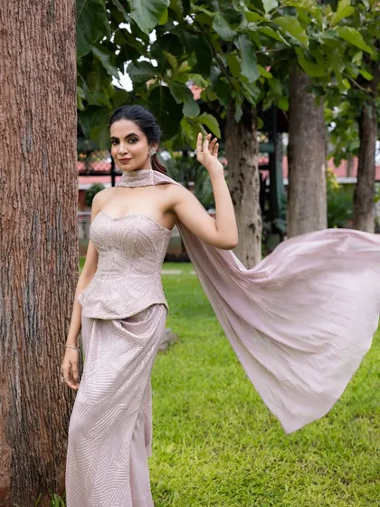 My designs also cater to modern celebrations. This elegant cocktail outfit features a structured, hand-embroidered corset top and a draped skirt, complete with a flowing scarf for a touch of drama, perfect for an evening of glamour.