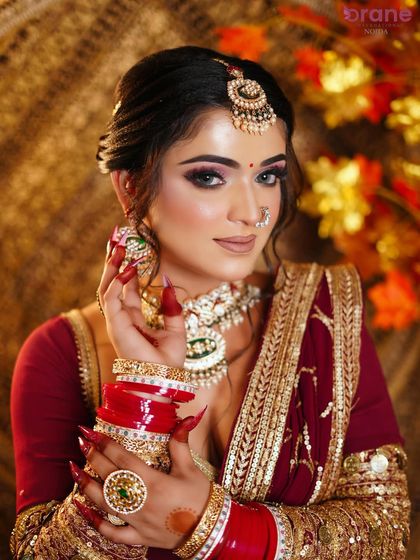 A close-up on the stunning details, from the sharp nail extensions to the intricate jewelry and flawless makeup.