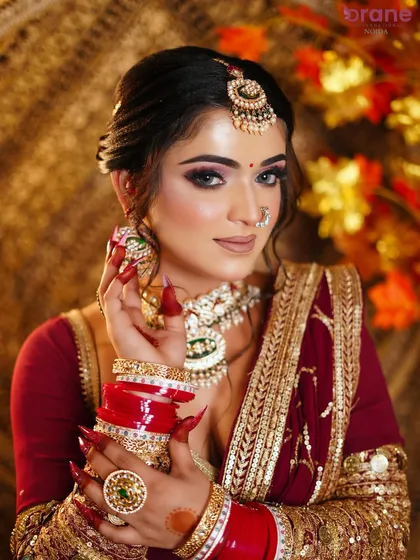 A close-up on the stunning details, from the sharp nail extensions to the intricate jewelry and flawless makeup.