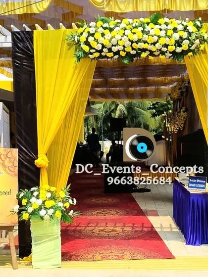 A bold and sunny entrance for a Roce ceremony. The bright yellow draping and floral arrangements create a cheerful and welcoming first impression for guests.