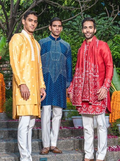 A vibrant trio of kurta sets in yellow, blue, and red. Each piece showcases a different style of embroidery and design, perfect for standing out during the wedding season.