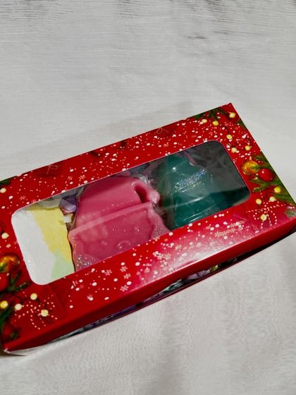 The festive red window box for our mini Christmas hamper, showing the cute holiday-themed soaps inside.