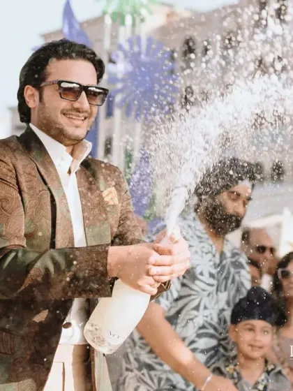 The groom pops a bottle of champagne at the Cuban Jazz brunch. These are the moments of effortless style and celebration that I love to orchestrate.