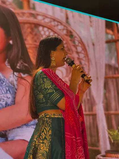 A side profile of me hosting, with a beautiful picture of the couple on the screen behind me. The event is always centered around their story.