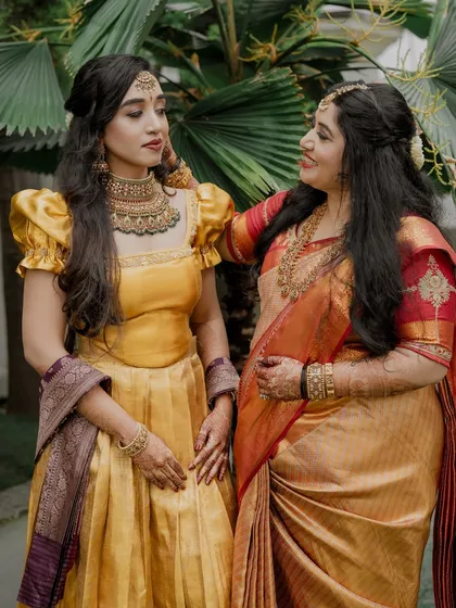 A heartwarming moment between the bride and a family member, both looking radiant with professional makeup that suits their individual styles.