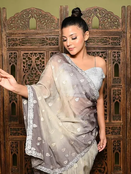 A classic and graceful pose that highlights the delicate border and fall of the saree. This shot focuses on the model's serene expression and the timeless appeal of the ethnic wear.