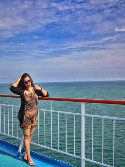 Onboard a cruise in Thailand. A printed romper with a black shrug is a comfortable and stylish choice for a day at sea.