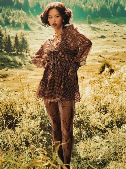 Experience the cinematic wilderness without leaving the studio. This image uses a warm, pastoral projection to create a dreamy, sun-drenched field, perfect for ethereal fashion concepts.