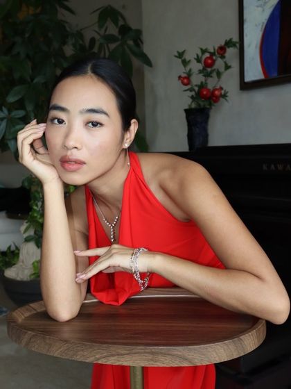 Another shot of our dainty jewellery set, styled with a classic red dress for a look of effortless elegance.