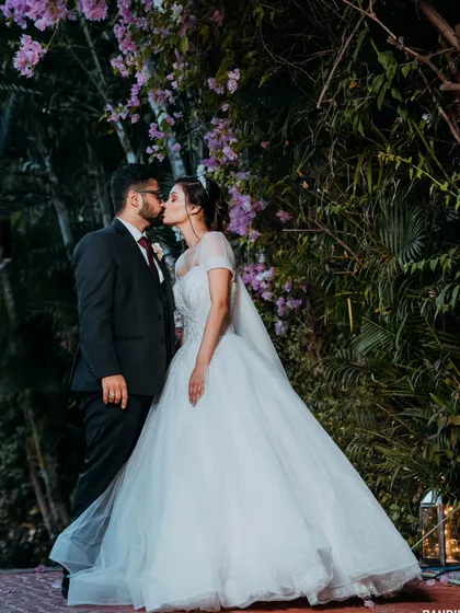 A fairytale moment captured under a canopy of flowers. While this is from a wedding day, it showcases the dramatic and romantic portrait style we bring to all our shoots, including pre-wedding sessions.