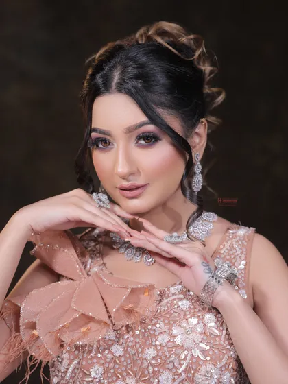A close-up of a model with a beautiful updo and soft glam makeup. This look is perfect for an engagement or reception, showcasing skills in both hair and makeup.