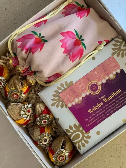 Another angle of my traditional Rakhi hamper, showing the beautiful lotus-print potli bag alongside the decorated coconuts and gift box. It’s a perfect blend of ritual and thoughtful gifting.