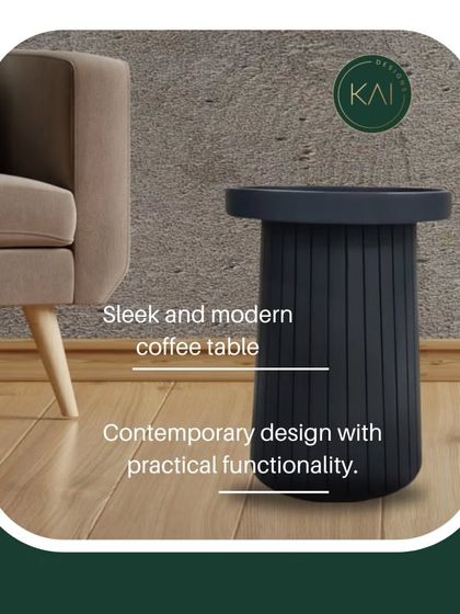 A modern coffee table with a fluted base and a dark, matte finish. Its simple, cylindrical form and practical functionality make it a versatile piece for any contemporary living space.