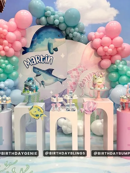 An underwater theme with sharks and whales, perfect for a child who loves marine life. The setup includes multiple plinths for a large dessert display.