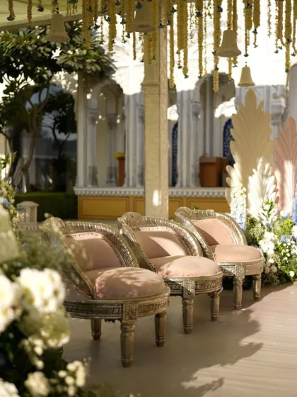 Elegant silver chairs for family seating, set against the backdrop of the hanging floral ceiling.