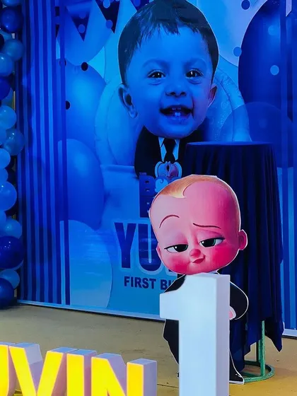 Another angle showing the Boss Baby prop in front of a personalized backdrop featuring the birthday boy's picture.