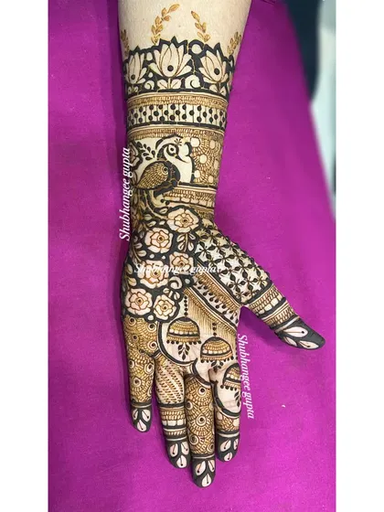 A beautiful design-on-demand featuring a peacock, lotus flowers, and hanging jhumkas. It's a perfect mix of classic and playful elements.