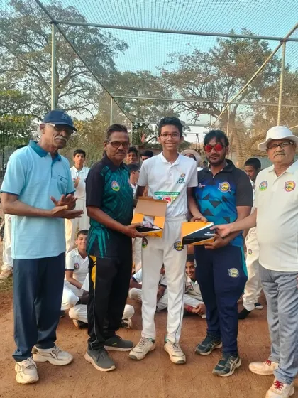 Presenting new cricket shoes to a deserving player during the MPL U-14 awards. Proper gear is essential for performance.