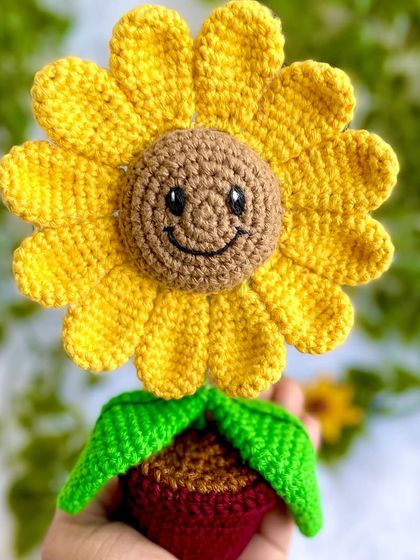 A close-up of the smiling sunflower's face. It’s the little details like the embroidered smile and eyes that give it so much personality.