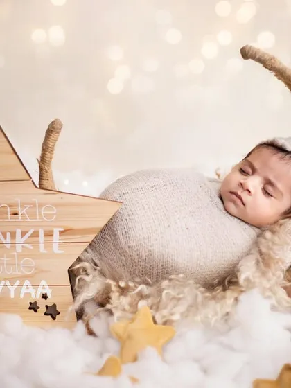 How dreamy is this "Twinkle Twinkle Little Star" setup? I love bringing your creative ideas to life. Here, little Gavyaa is sleeping peacefully on a moon prop, surrounded by fluffy clouds and stars.