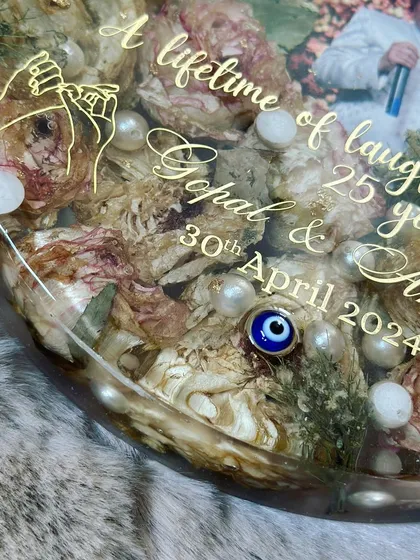 A close-up of the engraved details on an anniversary keepsake. I included a small graphic of holding hands to symbolize their journey together.