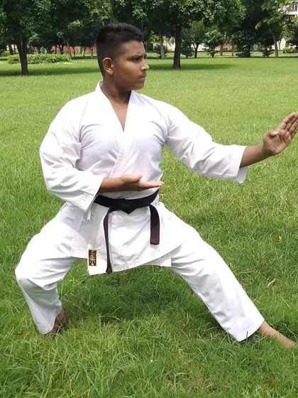 My brother demonstrating a perfect defensive stance during outdoor practice. We train together often, pushing each other to improve.