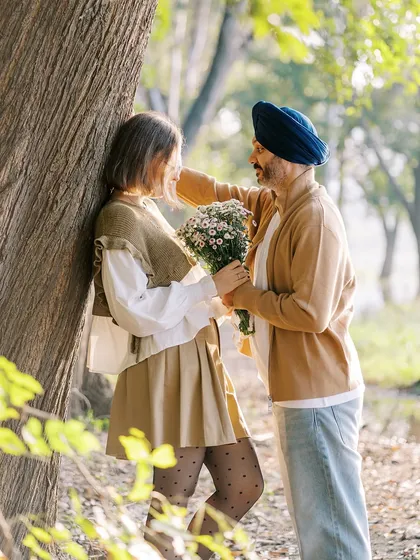 A sweet, romantic moment in the woods. He offers her a bouquet of flowers, a classic gesture of love that I was happy to capture for their love story session.