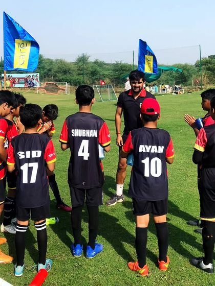 Courage and guidance. Our coach giving a pre-game talk to the team, instilling confidence and strategy.