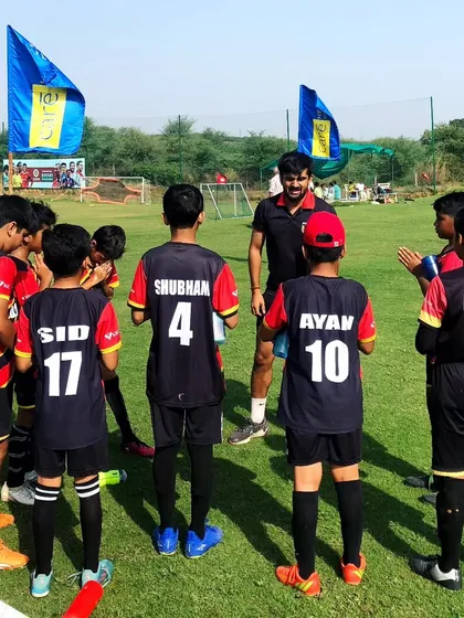 Courage and guidance. Our coach giving a pre-game talk to the team, instilling confidence and strategy.