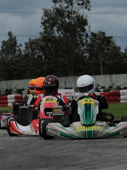 A tight pack of karts during the Meritus Cup, where every position is hard-fought.