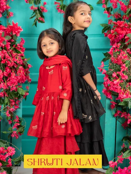 Sisters back-to-back in their red and black sharara sets. The contrast is striking and perfect for girls who love to make a style statement.