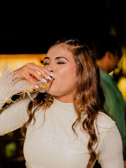 The bride-to-be enjoying her cocktail party, with her trendy braided hairstyle looking flawless.