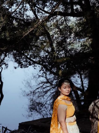 A wide shot of the couple during their Haldi ceremony by the lake in Nainital, showcasing the beauty of a destination wedding.